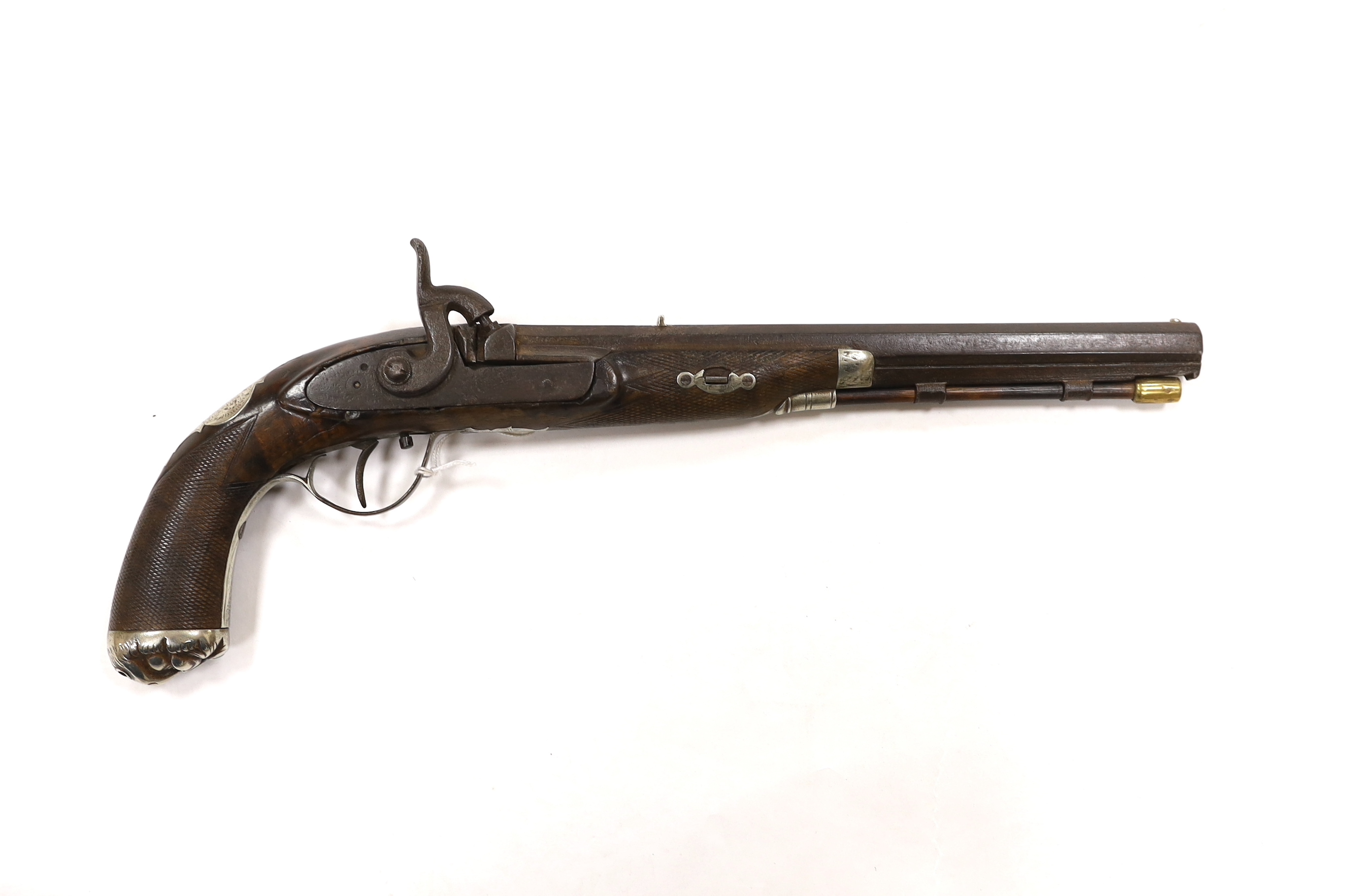 A 22 bore percussion holster pistol probably made for the Indian market, octagonal barrel with nickel sight, chequered walnut stock, engraved nickel furniture with grotesque mask butt cap